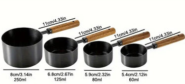 Set of black measuring cups with wooden handles and measurements on a white background